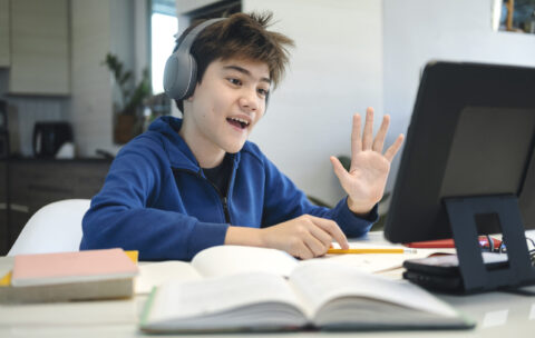 Young collage student using computer and mobile device studying