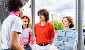 Group of young happy friends visiting Paris and Eiffel Tower