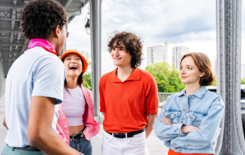 Group of young happy friends visiting Paris and Eiffel Tower